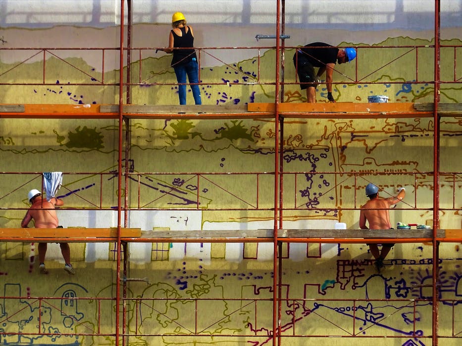a few people standing in a kwikstage scaffolding